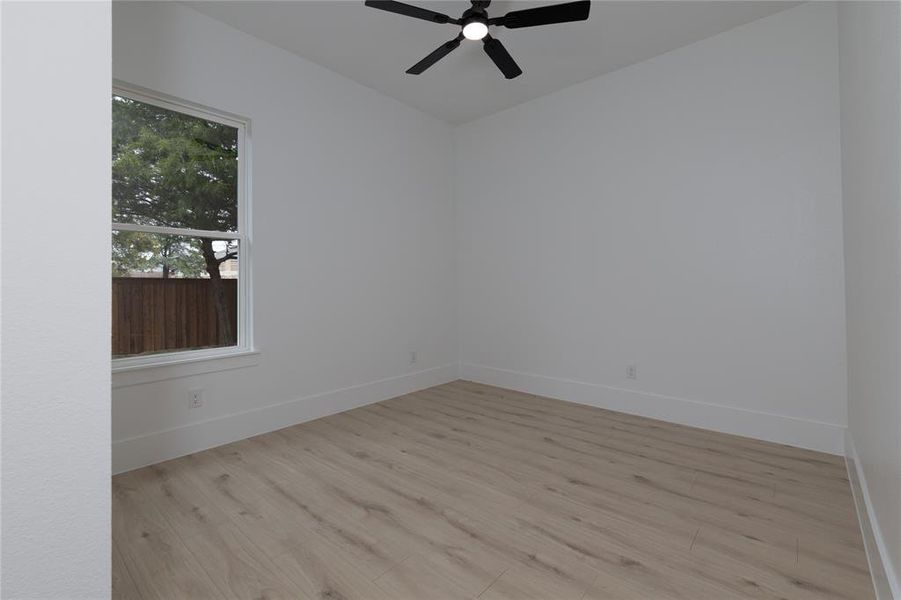 Unfurnished room featuring wood finished floors and ceiling fan