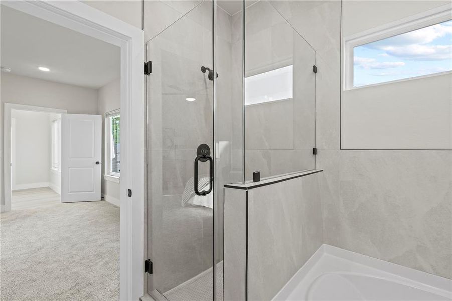 Bathroom with a shower stall and a bath Bathroom with a shower stall and a bath