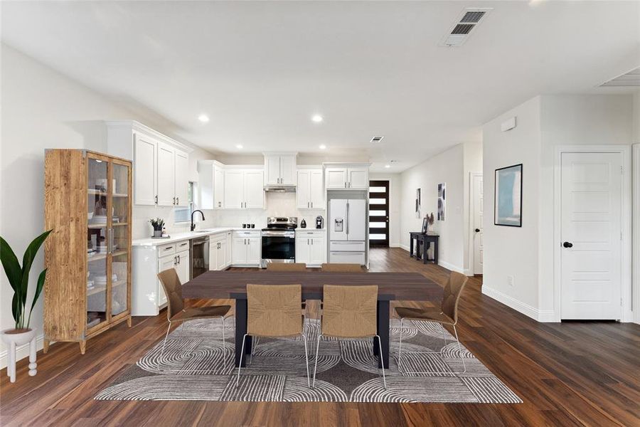 Dining space with dark wood-style flooring and recessed lighting