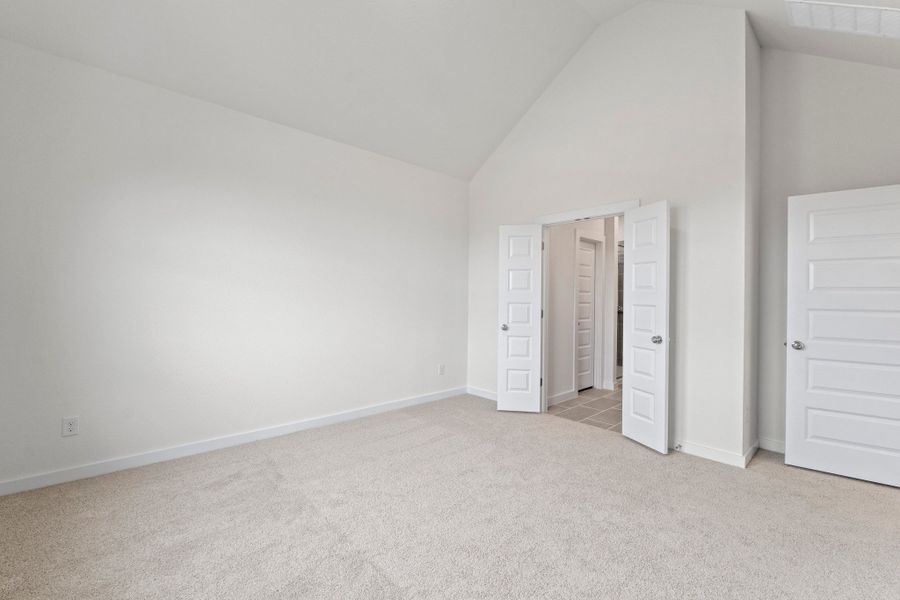 Primary Bedroom in the Pearl home plan by Trophy Signature Homes – REPRESENTATIVE PHOTO