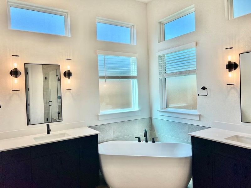 Full bath with a freestanding tub and two vanities