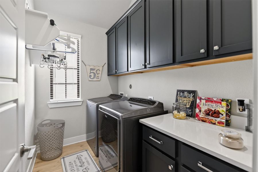 Large in house utility room with plenty of storage.