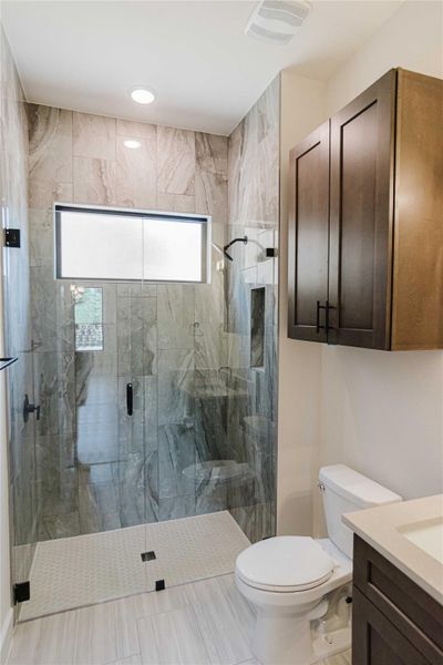 Full bath with vanity and a stall shower