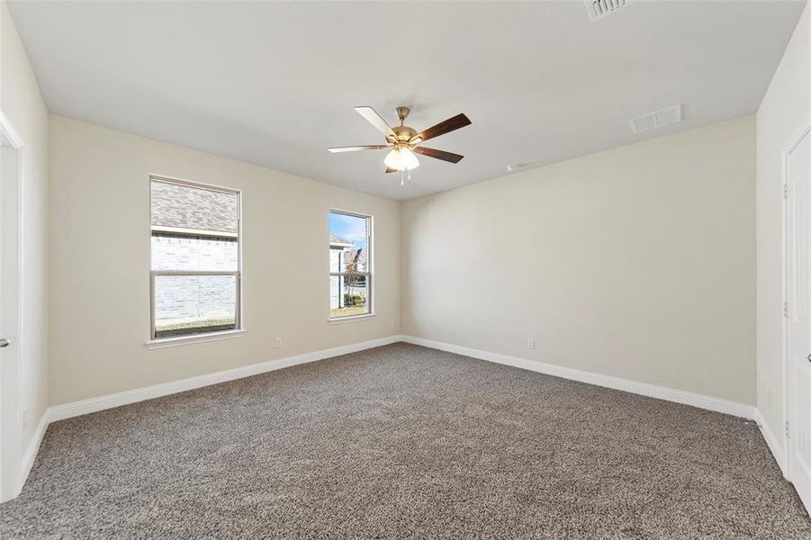 Spare room featuring carpet flooring and ceiling fan