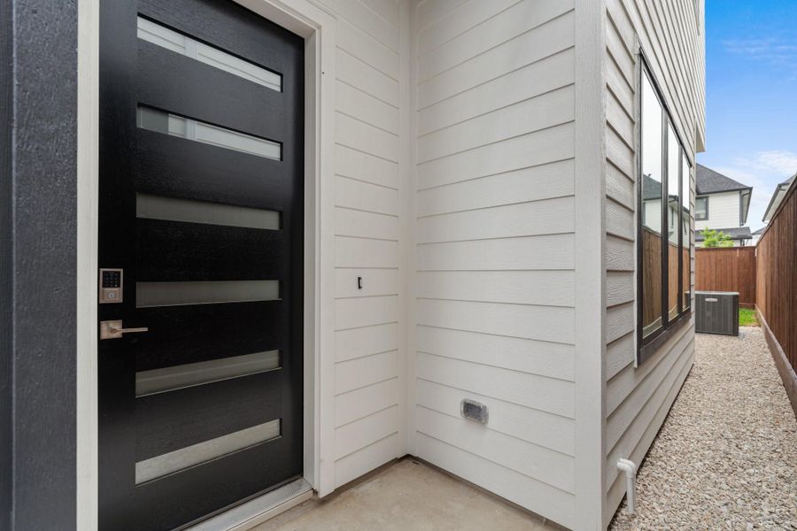 Secure and stylish entry with a designer wood and frosted glass front door, plus a 7’ steel security gate with a digital locking system. Secure and stylish entry with a designer wood and frosted glass front door, plus a 7’ steel security gate with a digital locking system.