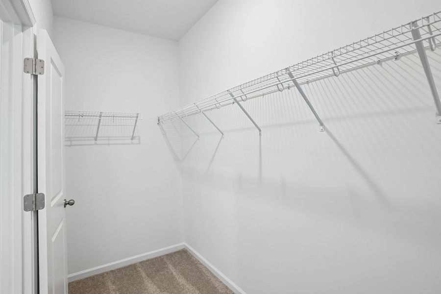Primary Walk-In featuring the AW Collection® Serene - Open storage with understated design.
