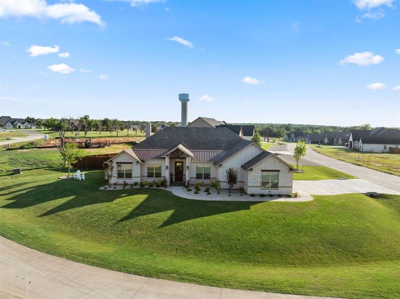 Front exterior of a new home in Pecan Plantation, Granbury, TX, highlighting curb appeal (Image 22).