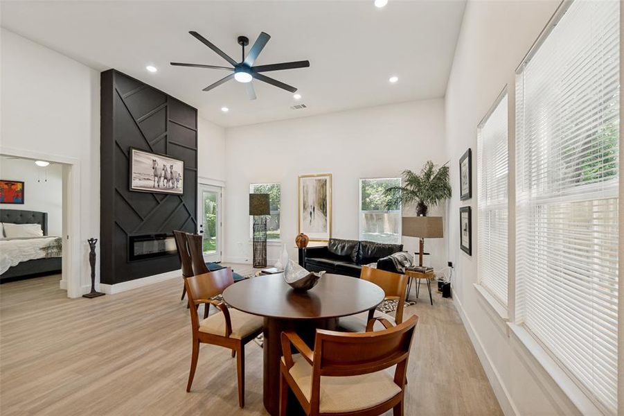 Open-concept living area with a vaulted ceiling and light wood-finish flooring Open-concept living area with a vaulted ceiling and light wood-finish flooring