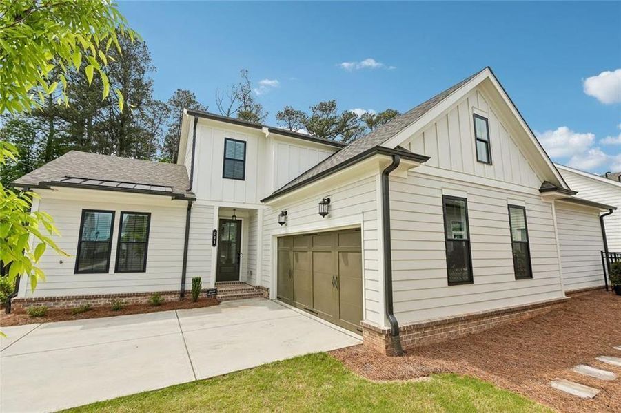 Front exterior of a new home in Promenade at Sawnee Village, Cumming, GA, highlighting curb appeal (Image 1). Front exterior of a new home in Promenade at Sawnee Village, Cumming, GA, highlighting curb appeal (Image 1).