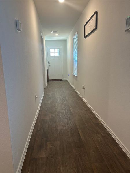 Entryway featuring wood finished floors and baseboards