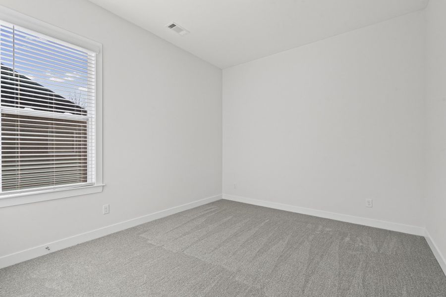 Unfurnished room featuring carpet floors and baseboards