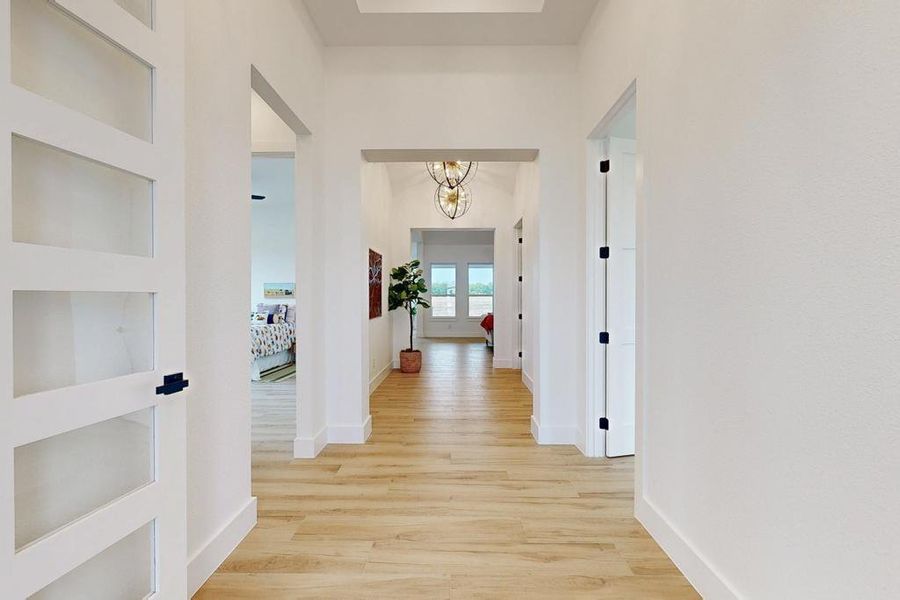 Hall with light wood-style floors and a chandelier Hall with light wood-style floors and a chandelier