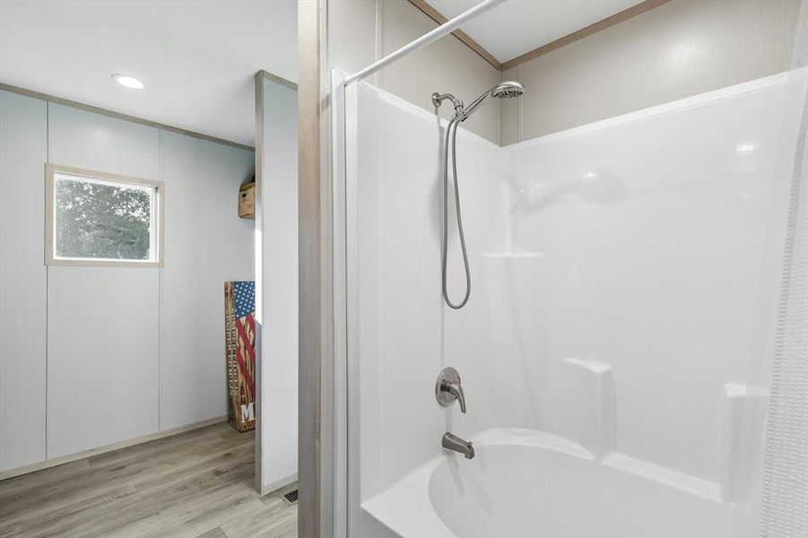 Full bath with shower / bath combination with curtain, light wood-type flooring, and recessed lighting Full bath with shower / bath combination with curtain, light wood-type flooring, and recessed lighting