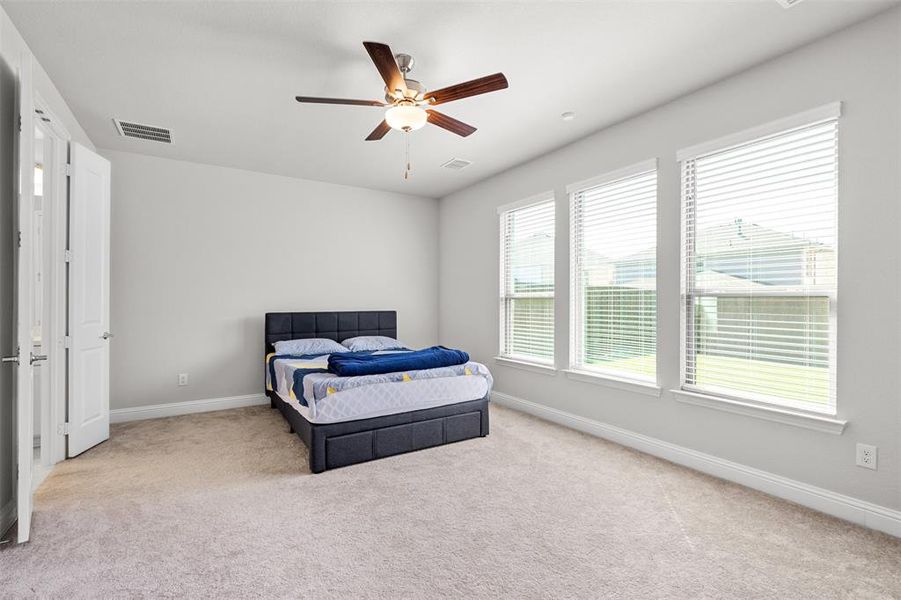 Bedroom with ceiling fan and carpet flooring