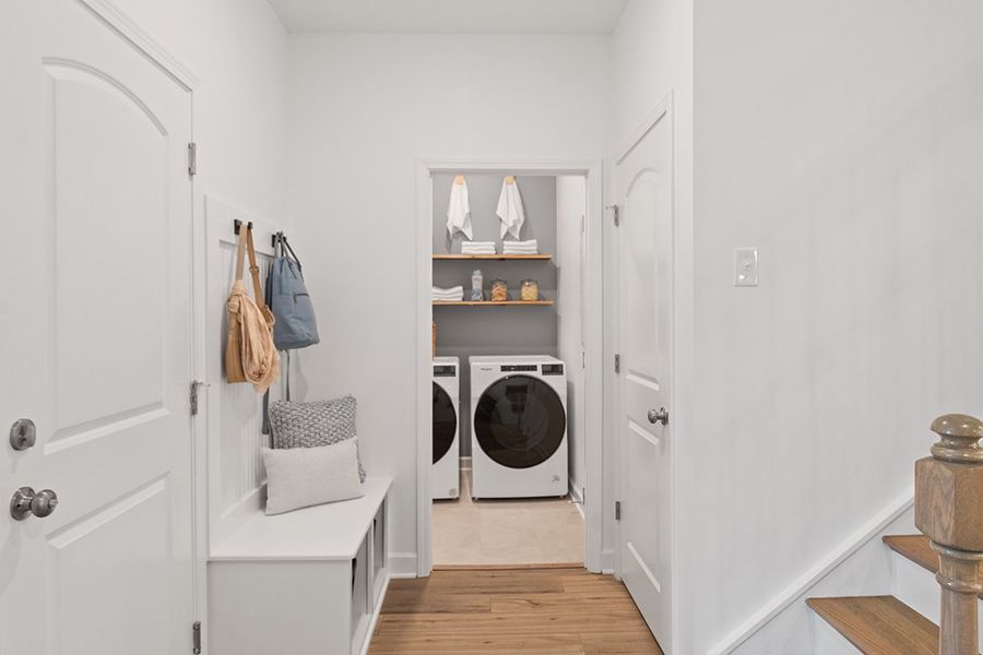 A room with a white door and a white shelf with a fan.