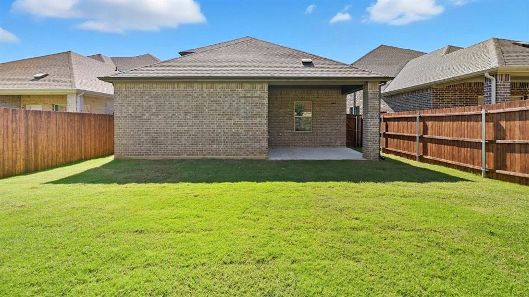 Rear view of property featuring a patio area, brick siding, a shingled roof, and a fenced backyard Rear view of property featuring a patio area, brick siding, a shingled roof, and a fenced backyard