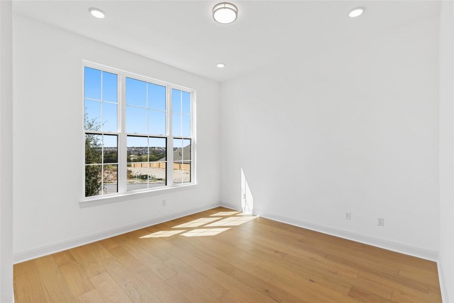 Spare room with light wood-style flooring and recessed lighting