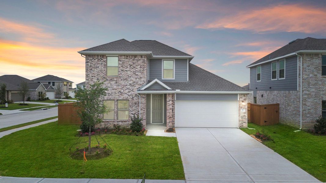 Front exterior of a new home in River Ranch Trails, Dayton, TX, highlighting curb appeal (Image 14).