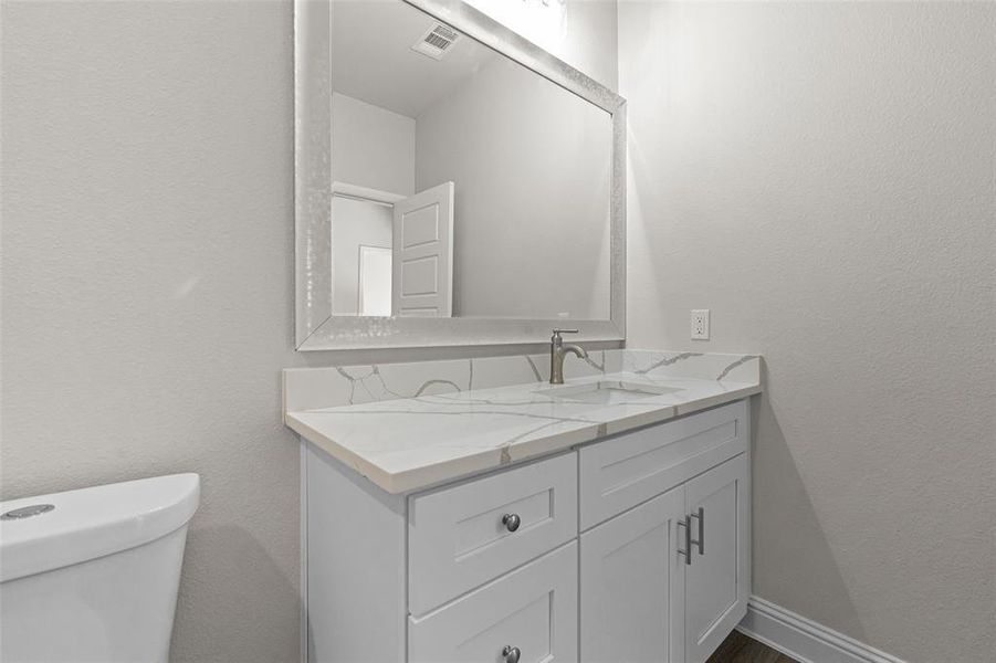 Bathroom featuring vanity and toilet