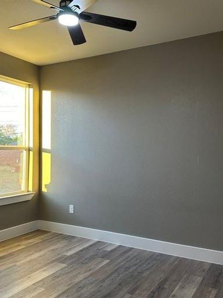 Unfurnished room featuring ceiling fan and hardwood / wood-style floors