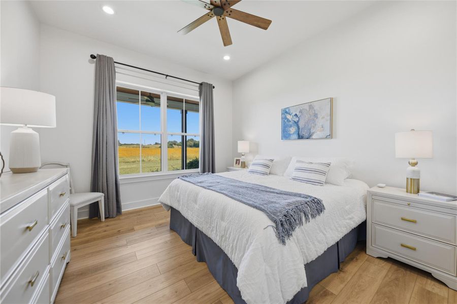 A tranquil sanctuary features a countryside outlook and hardwood flooring, perfect for serene mornings.
