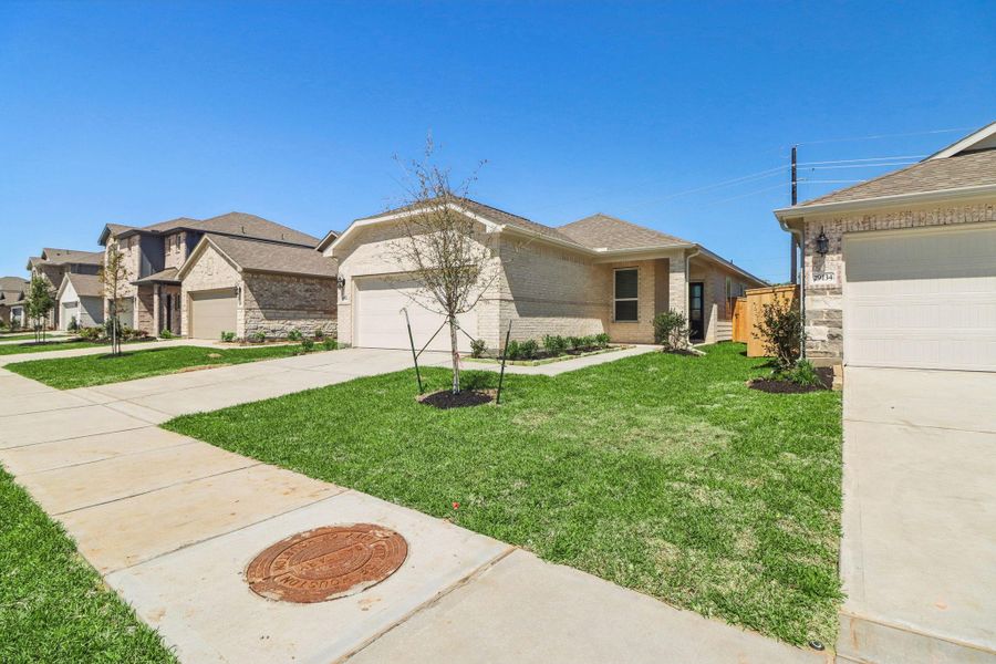 Front exterior of a new home in Sanford Farms - Traditional Series, Conroe, TX, highlighting curb appeal (Image 19).