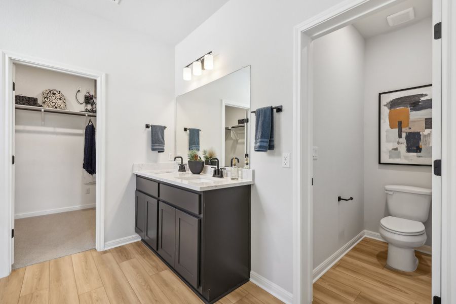 A bathroom with a toilet and sink.