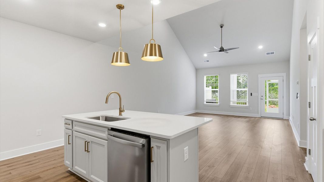 Exclusive DRB Homes kitchen with a center island, elevated finishes, and pendant lighting in a prime location Exclusive DRB Homes kitchen with a center island, elevated finishes, and pendant lighting in a prime location