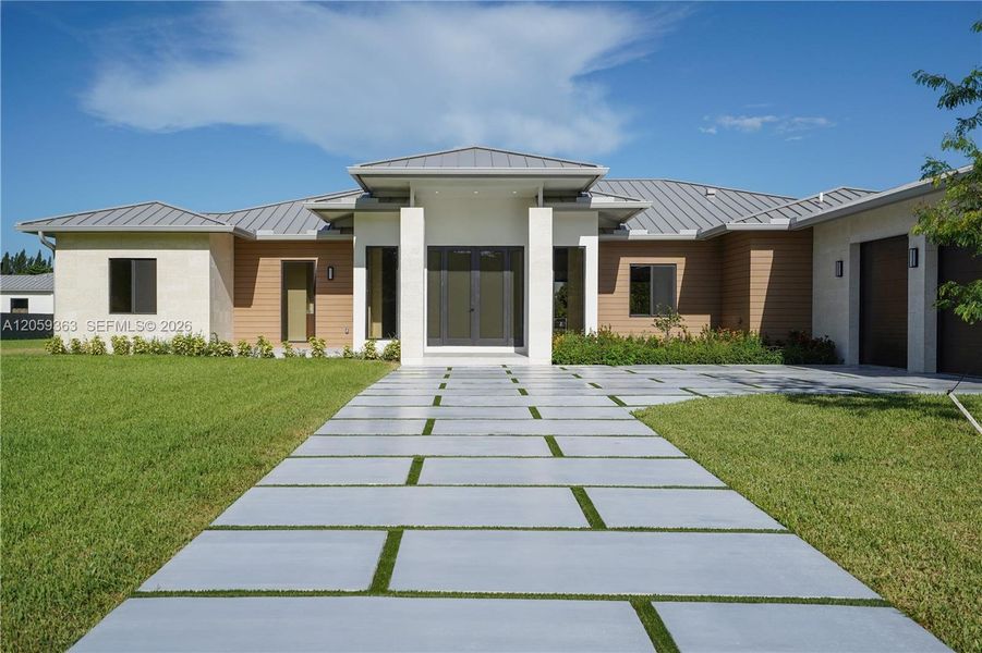 Front exterior of a new home in , Homestead, FL, highlighting curb appeal (Image 1). Front exterior of a new home in , Homestead, FL, highlighting curb appeal (Image 1).