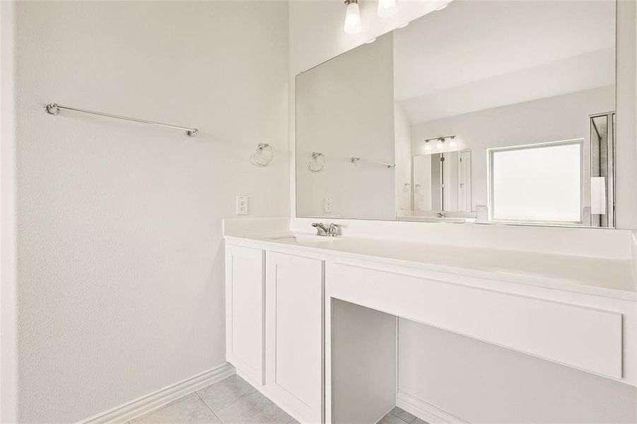 Bathroom featuring vanity and tile patterned flooring