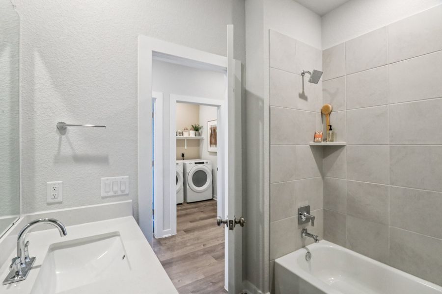 A bathroom with a sink and a bathtub. A bathroom with a sink and a bathtub.