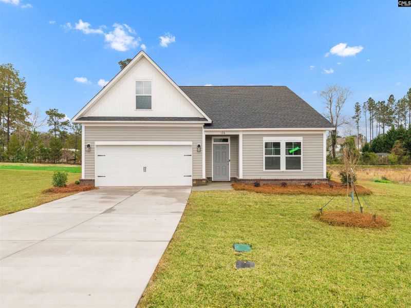 Front exterior of a new home in Raglins Creek, Lugoff, SC, highlighting curb appeal (Image 2). Front exterior of a new home in Raglins Creek, Lugoff, SC, highlighting curb appeal (Image 2).