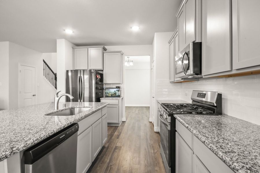 Another view of the kitchen with formal dining entry straight ahead
