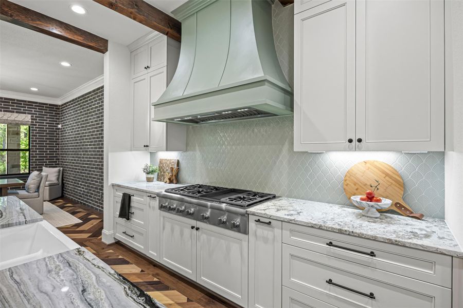 Premium gas range paired with a beautifully crafted custom hood. Premium gas range paired with a beautifully crafted custom hood.