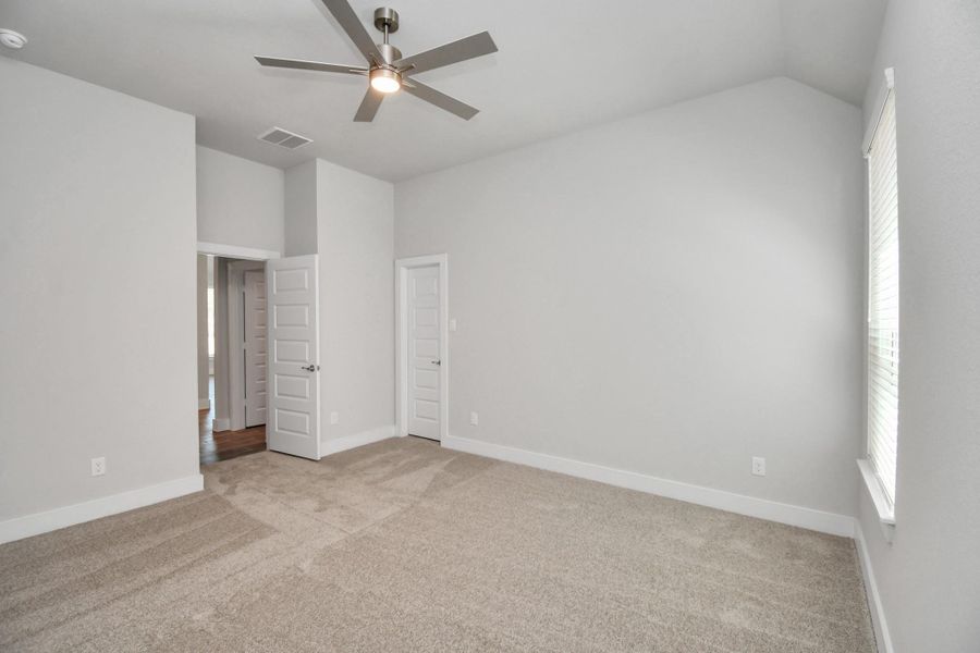 Secondary bedroom features plush carpeting, large windows that let in plenty of natural light, bright paint, and spacious closets. Sample photo of completed home with similar floor plan. Actual colors and selections may vary. Secondary bedroom features plush carpeting, large windows that let in plenty of natural light, bright paint, and spacious closets. Sample photo of completed home with similar floor plan. Actual colors and selections may vary.