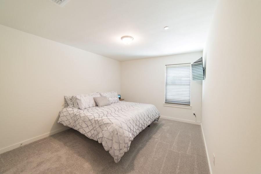 Carpeted bedroom with baseboards
