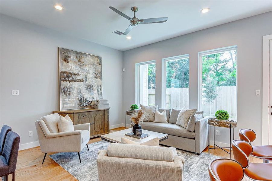 Beautiful big windows overlooking the backyard and a sleek open floor plan makes for the perfect entertainment area for friends and family.