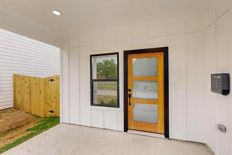 Doorway to property with board and batten siding Doorway to property with board and batten siding