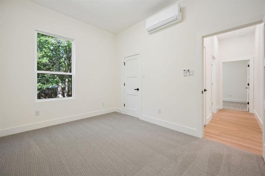 First floor bedroom with light colored carpet.