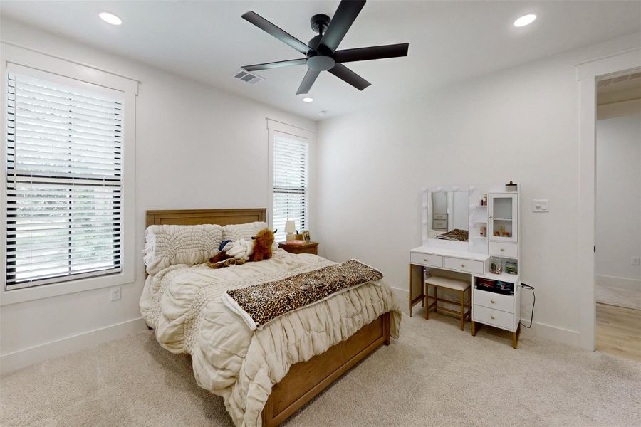 Bedroom with light colored carpet, recessed lighting, and ceiling fan