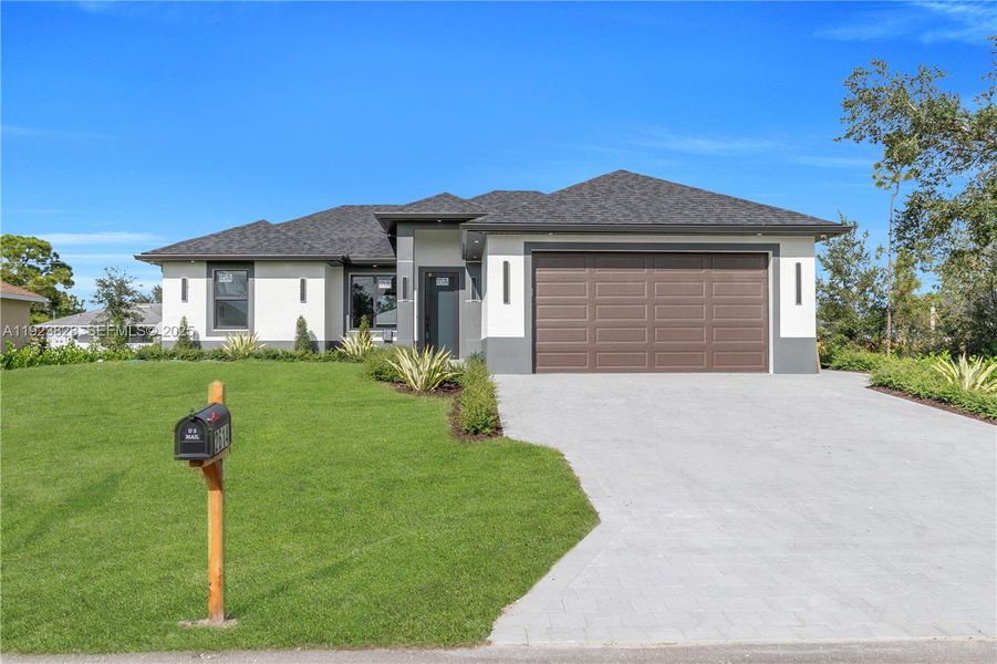 Front exterior of a new home in , Lehigh Acres, FL, highlighting curb appeal (Image 29).
