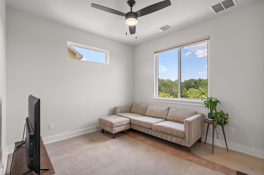 A quiet secondary bedroom offers ample natural light and a refreshing outdoor vista. A quiet secondary bedroom offers ample natural light and a refreshing outdoor vista.