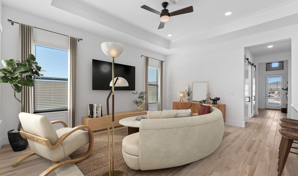 Great room with tray ceiling and wood-look tile flooring