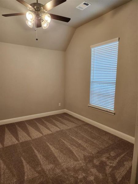 Unfurnished room with carpet floors, ceiling fan, and lofted ceiling