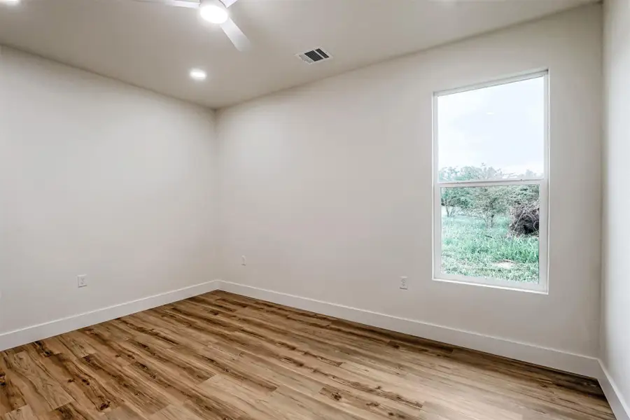 Spacious bedroom offering flexibility for a guest room, office, or creative space