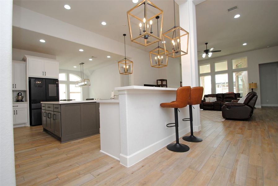 Entryway take you to the kitchen, the living area w/it's wall of windows and the dining area with light flowing in.