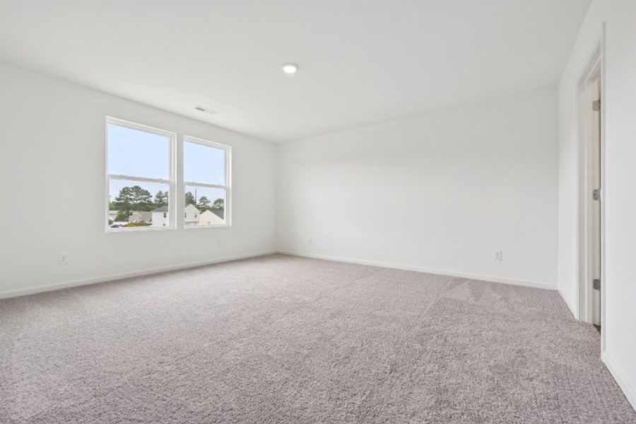 A room with a carpet and windows. A room with a carpet and windows.