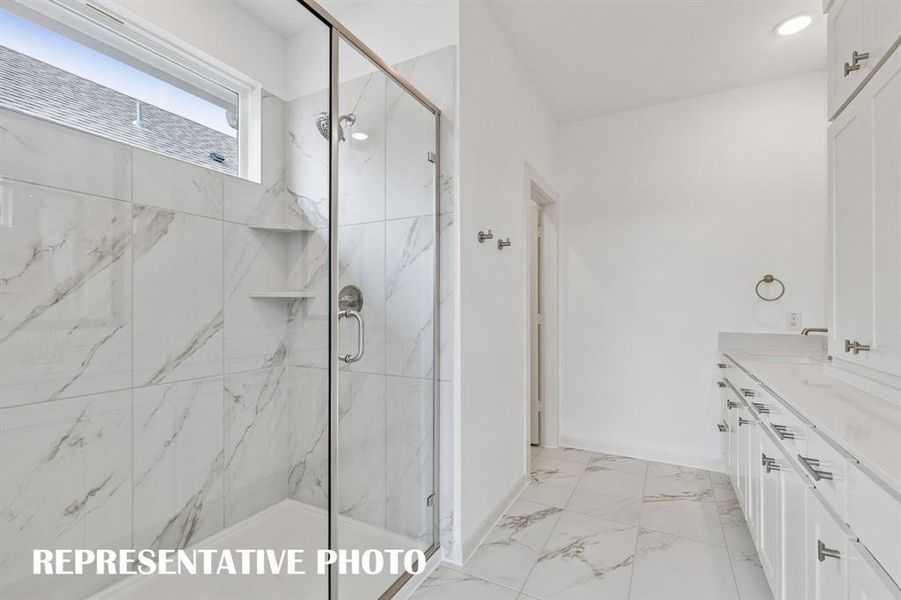 Featuring an oversized walk in shower, this dream owner's bath is waiting for you to call it your own!  REPRESENTATIVE PHOTO