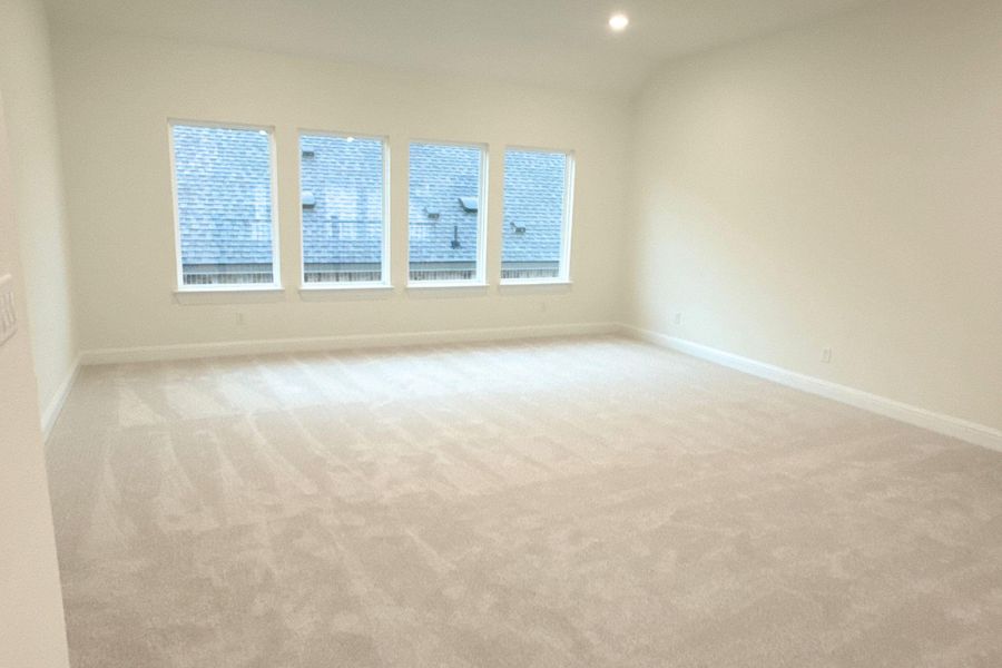 Unfurnished room with light carpet, lofted ceiling, and recessed lighting