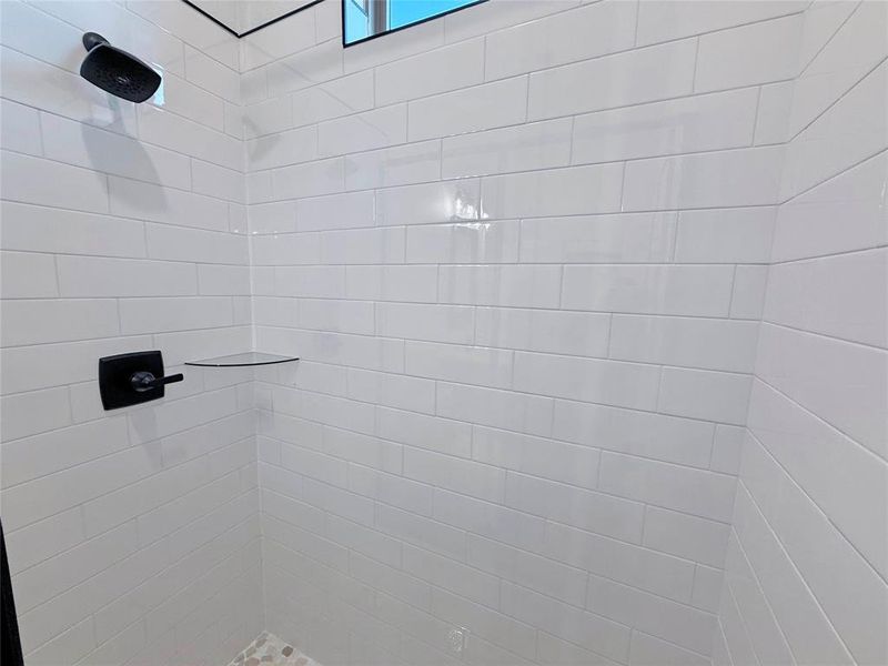 Full bath featuring tiled shower
